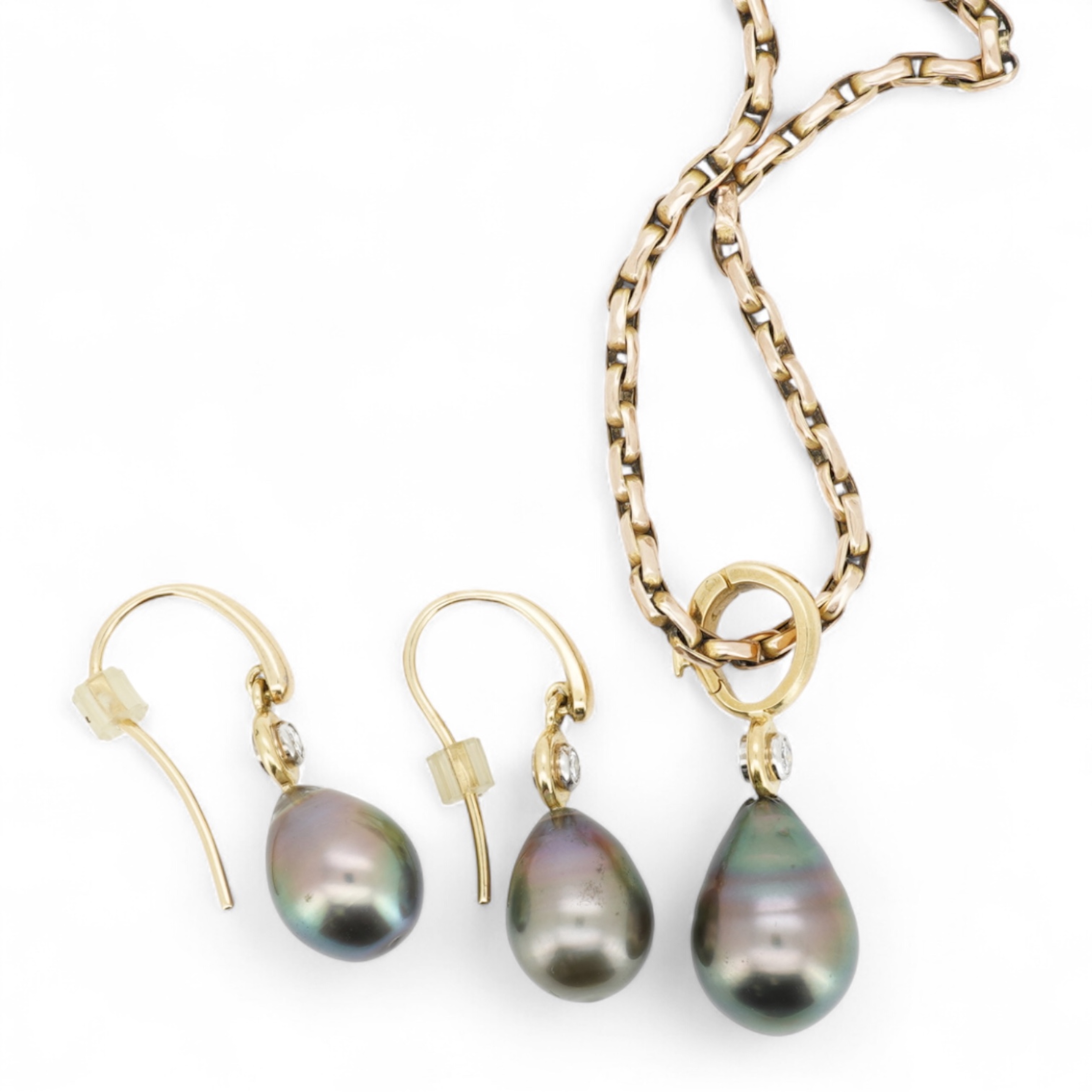 A cultured pearl and diamond demi-parure, comprising: a pendant, suspending a drop-shaped cultured pearl of black tint, measuring approximately 15 x 10.5 x 10.5mm, surmounted by a collet-set brilliant-cut diamond weighin